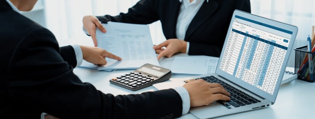 how to report cash tips for income tax - A corporate accountant team uses accounting software on a laptop to calculate financ